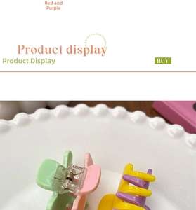 Detail of candy-colored hair claw clip with contrast tones on a white ceramic plate