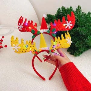 Detail of red and yellow LED Christmas reindeer antler headbands with hats and holly
