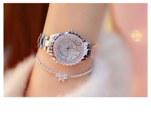 Close-up of luxury silver women's watch and bow bracelet set with sparkling rhinestones