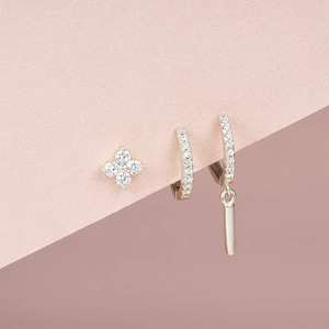 Detailed macro view of silver s925 earring set with flower stud and zircon dangles
