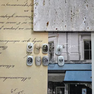Detail of vintage Baroque 3D nail art stickers with metallic heart and cross reliefs