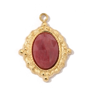 Detailed macro view of a gold-plated rhombic pendant with a polished red gemstone inlay