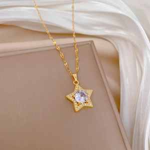 Close-up of gold star necklace with round zircon center on white satin background