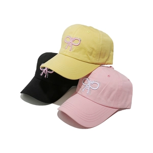 Women's cotton baseball caps with rhinestone bow decoration in yellow, black, and pink