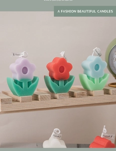 Detail of creative tulip-shaped scented candles with purple and red tiered flower petals