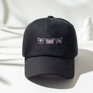 Close-up of black cotton baseball cap featuring three butterfly embroidery details