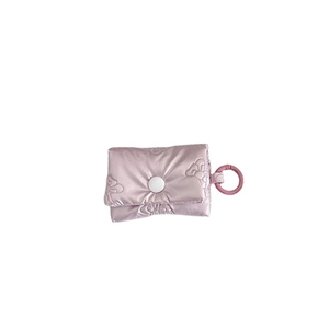 Light pink quilted pouch for AirPods case with bow-style stitching and snap button closure
