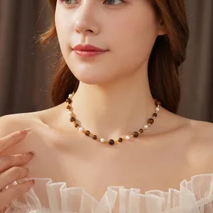 Vintage tiger eye and pearl beaded necklace on model for an elegant retro aesthetic