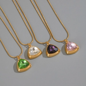 Detail of four geometric triangle pendants with zircon in green, white, purple and pink