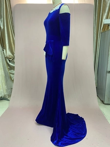 Close-up of royal blue velvet evening gown with lace cold shoulder and fishtail train