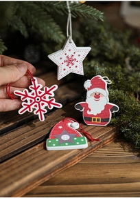 Detailed view of hand-painted wooden Christmas ornaments with stars and Santa Claus