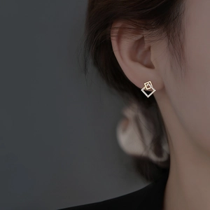 Elegant gold geometric square stud earrings featuring interlocking design and zircon stones