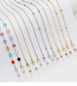 Detailed view of fashion eyewear chains with colorful zircons, pearls and lobster clasps