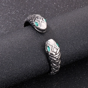 Vintage stainless steel open bangle with double snake heads and green gemstone eyes