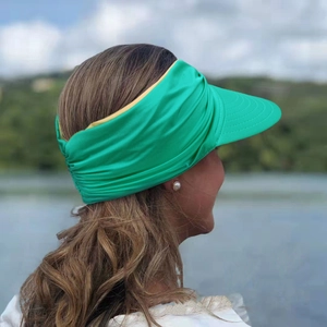 Detail of bright green open-top sun hat with wide elastic headband and sturdy brim