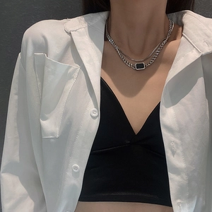 Modern double layer silver necklace with flat chain and rectangular black pendant on model