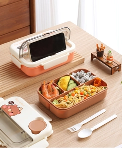 Detail of multi-compartment bento box with lid used as a phone holder for lunch