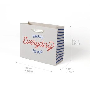 Detail view of cartoon paper gift bag with 18x7x15cm dimensions and white ribbon handles