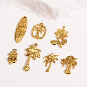Detailed view of golden ocean-themed metal charms including surfboards and palm trees