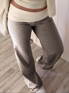 Detail view of high waisted striped lounge pants with a comfortable relaxed fit for women