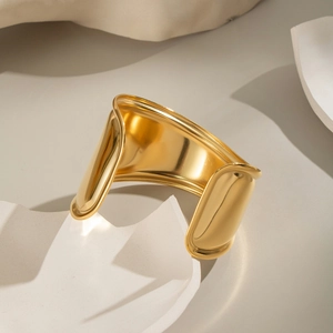 Macro view of wide wave cuff bracelet in 18K gold plated polished stainless steel