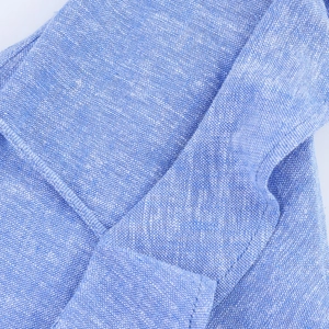 Macro shot of light blue woven fabric showing detailed high-density stitching and texture