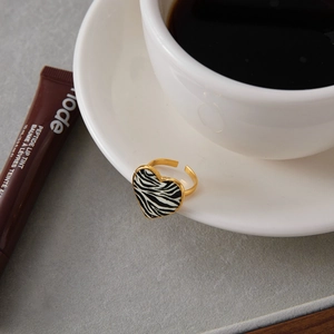 18K gold plated zebra print heart open ring displayed on a stylish ceramic cup