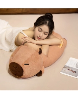 Close-up of soft brown capybara plush pillow with burger embroidery and high-density fabric