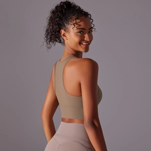 Detail view of khaki racerback sports bra and lilac high-waisted yoga leggings