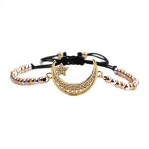 Close-up of adjustable woven bracelet with gold moon and star charms with zircons