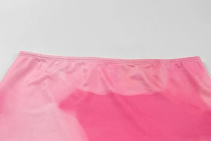 Detail shot of the pink gradient fabric with satin finish and neat edge stitching