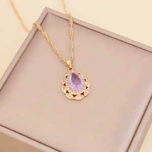 Golden teardrop necklace with purple gemstone and small diamonds on twist chain