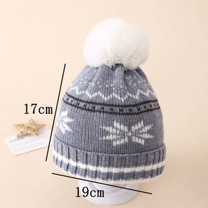Detail view of the winter knit hat showing white snowflake patterns and measurements