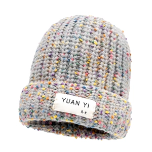Grey knitted beanie with colorful confetti pattern and woven label for winter warmth