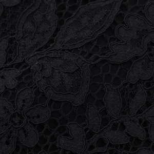 Macro shot of black floral hollow-out lace fabric texture and detailed craftsmanship