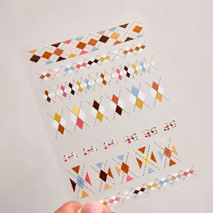 Detail of vintage argyle and bow pattern nail stickers with autumn color palette