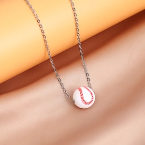 Macro view of a miniature baseball pendant with red stitching detail on a silver chain