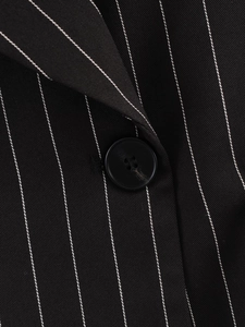 Close-up of black pinstripe blazer fabric texture and black four-hole button detail