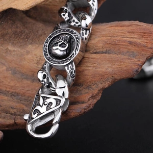 Macro detail of men's skull link bracelet featuring retro lobster clasp and antique finish