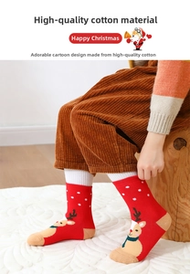 Close-up of thick Christmas socks with reindeer pattern and white dots for kids