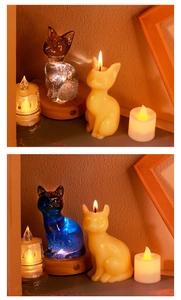 Macro shot of cat-shaped crystal resin and candle figures on glowing LED wooden base