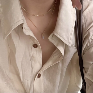 Double-layered 925 silver gold chain necklace with rectangular crystal pendant on model