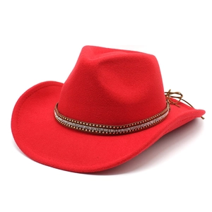 Detailed view of red cowboy hat with rhinestone studded brown leather band decoration