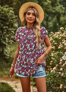 Detail of pink floral print top with ruffle sleeves and high round neckline on model
