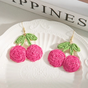 Handmade raffia cherry drop earrings in magenta and green for bohemian beach vacations