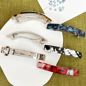 Macro view of assorted acetate hair clips with tortoiseshell and marble patterns