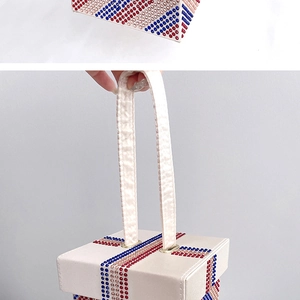Detail shot of the rhinestone rainbow handbag showing crystal patterns and top handle