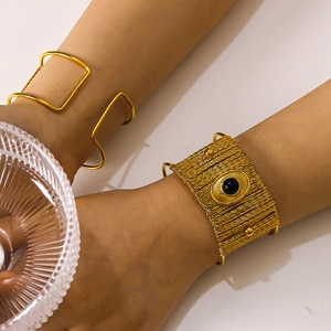 18K gold plated titanium steel bangles featuring woven texture and natural black stone