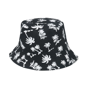 Detailed view of black bucket hat with white palm tree print and durable cotton fabric