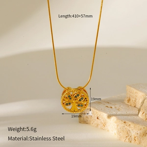 Macro shot of 18k gold plated tree of life pendant with blue gem on stainless steel chain